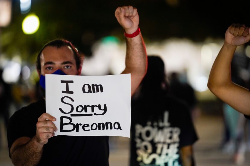 Demonstrators block the intersection of  McKinney at Pearl as they march through the Uptown...