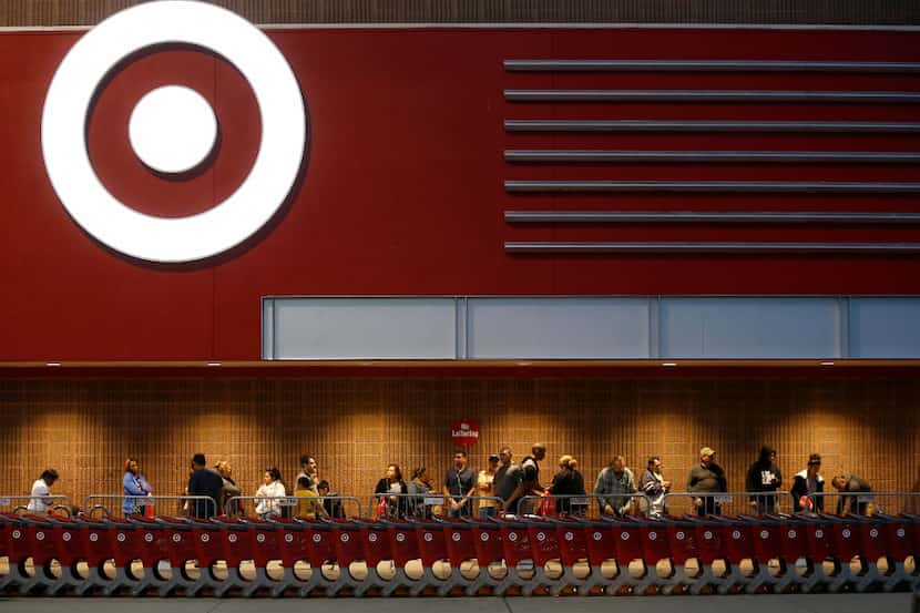 Shoppers stand in line at the Target Cityplace store on Thanksgiving Day in Dallas,...