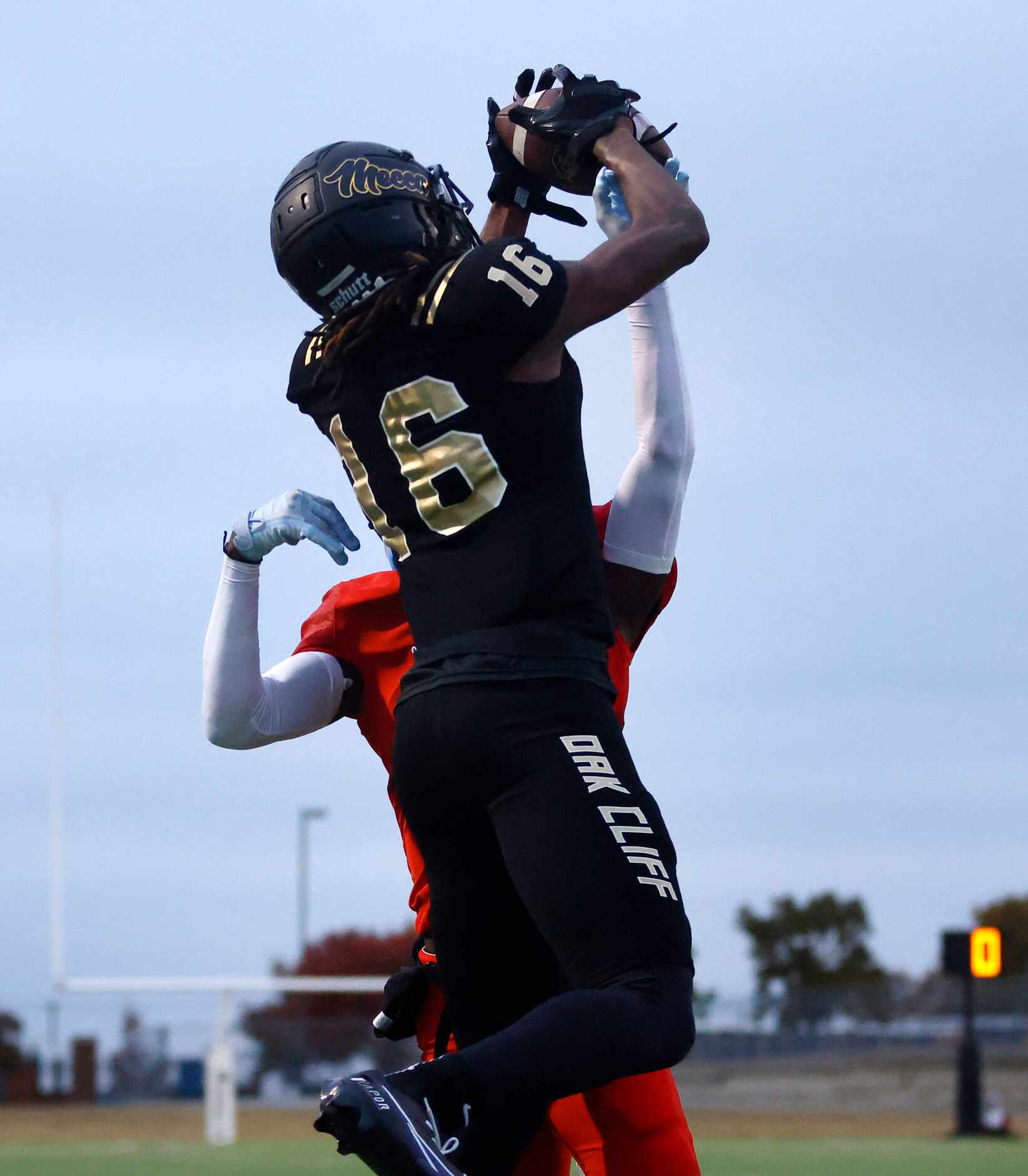 South Oak Cliff wide receiver Trey Jackson (16) goes up and over Midlothian Heritage...