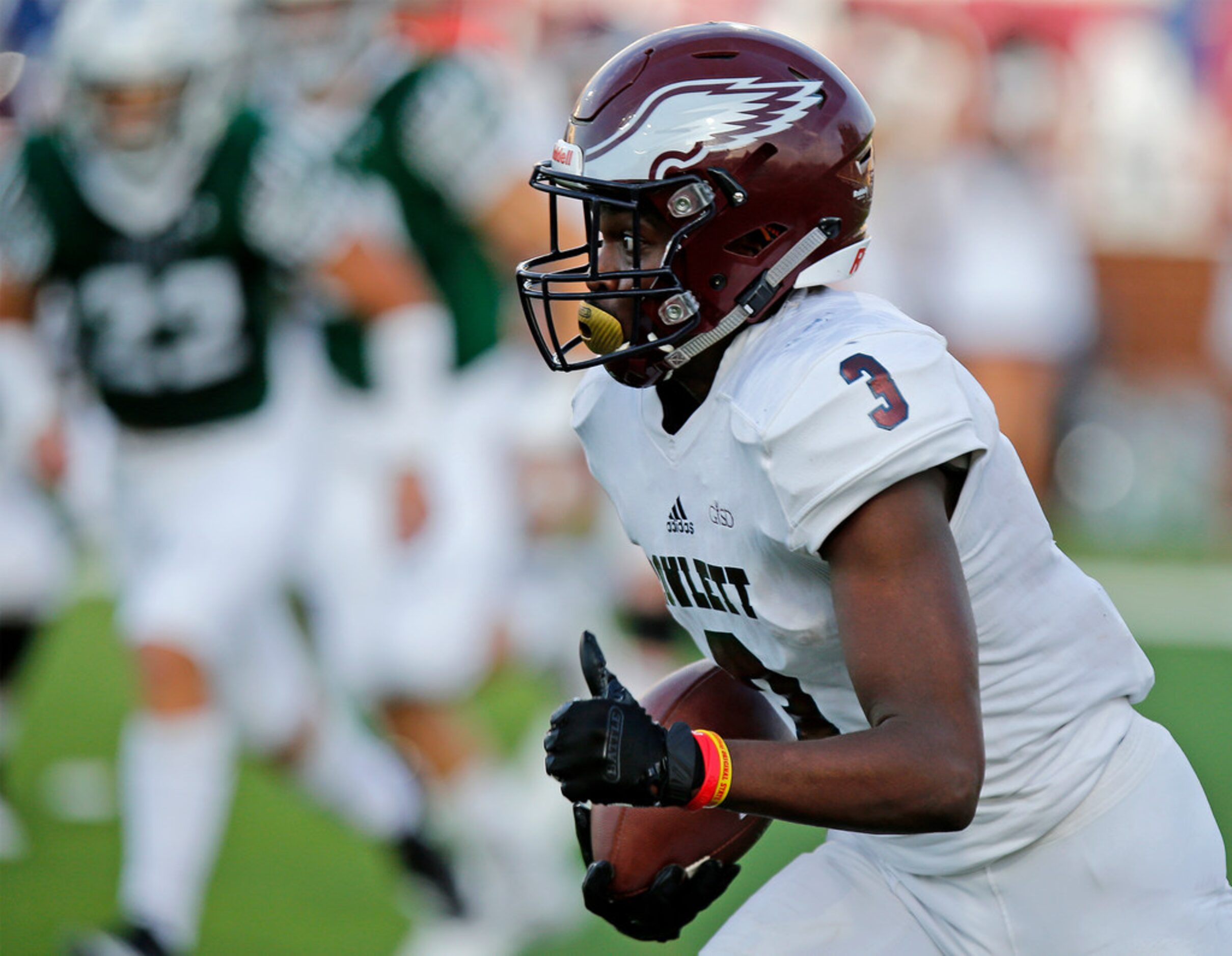 Rowlett High School wide receiver Treâvon King (3) runs for yardage after the catch during...