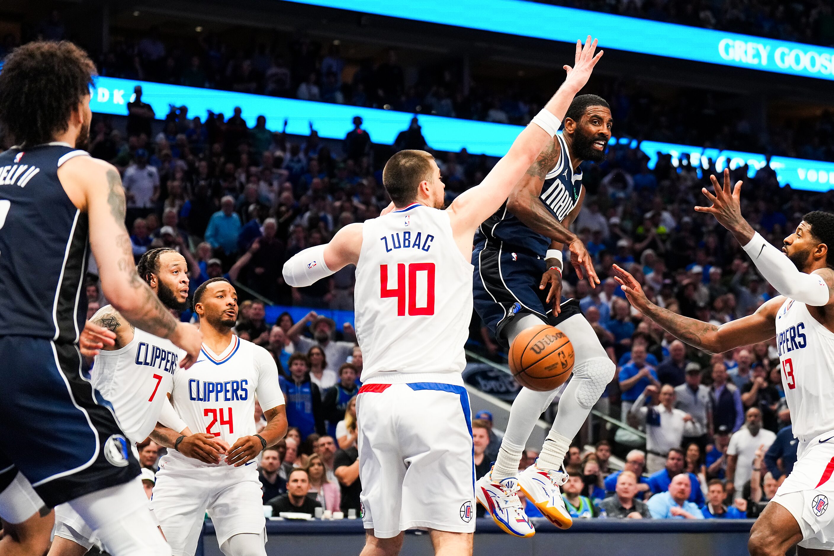 Dallas Mavericks guard Kyrie Irving (11) passes the ball to center Dereck Lively II (2)...