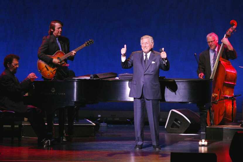 Tony Bennett makes a thumbs-up hand signal as he's applauded during a performance at...