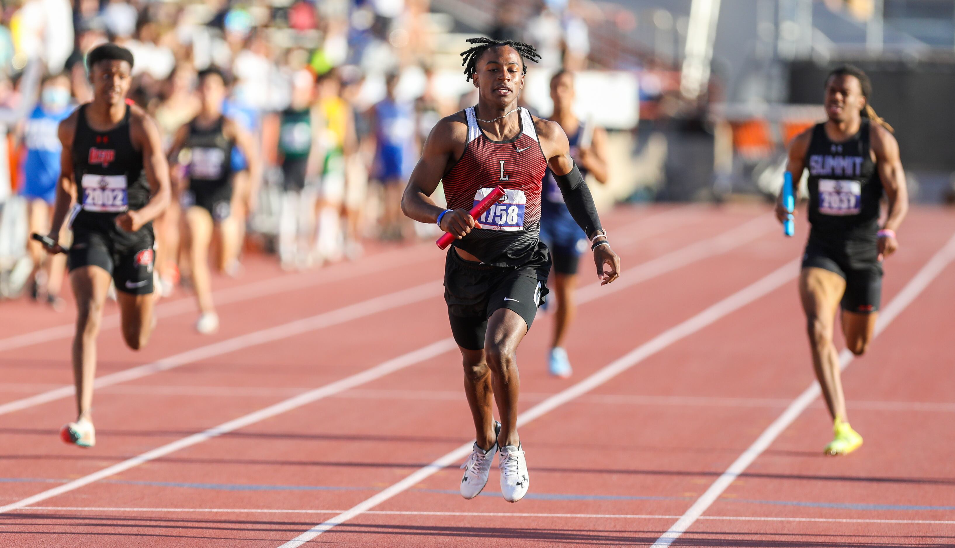 Frisco Liberty's Evan Stewart runs towards the finish line in the 5A Boys 4x200 relay during...