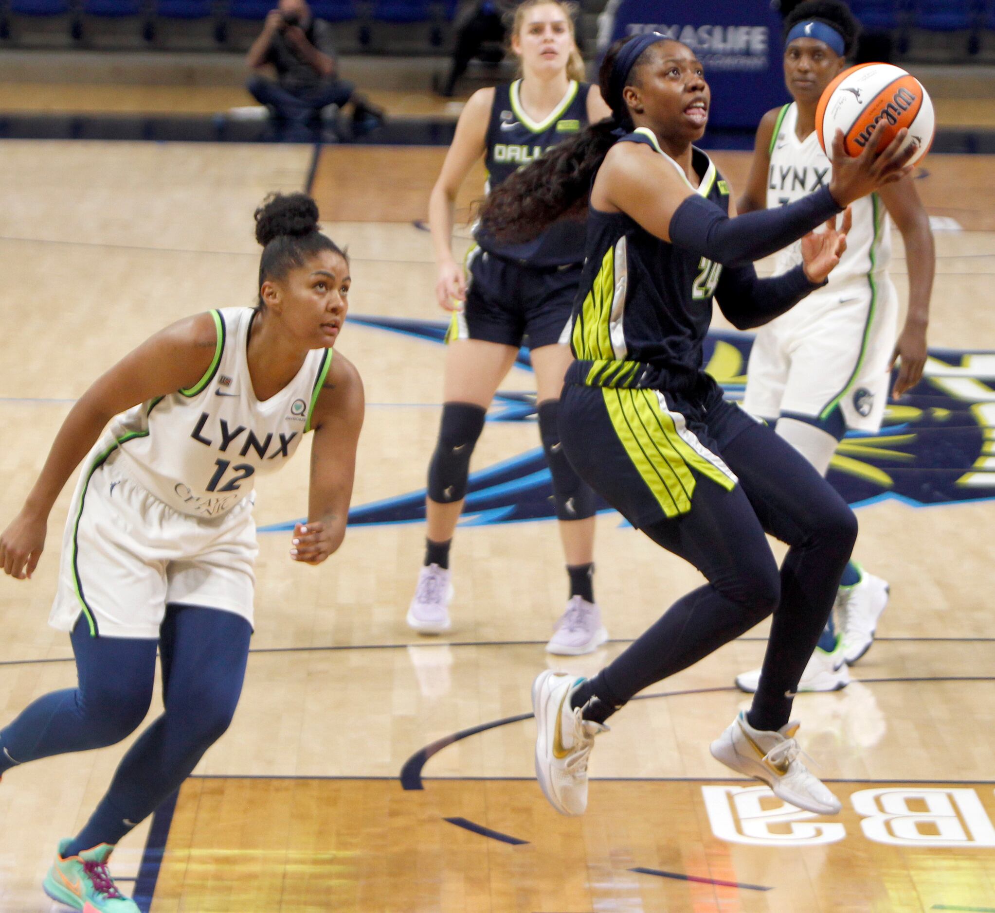 Dallas Wings guard Arike Ogunbowale (24) skies to the basket for a layup after avoiding the...
