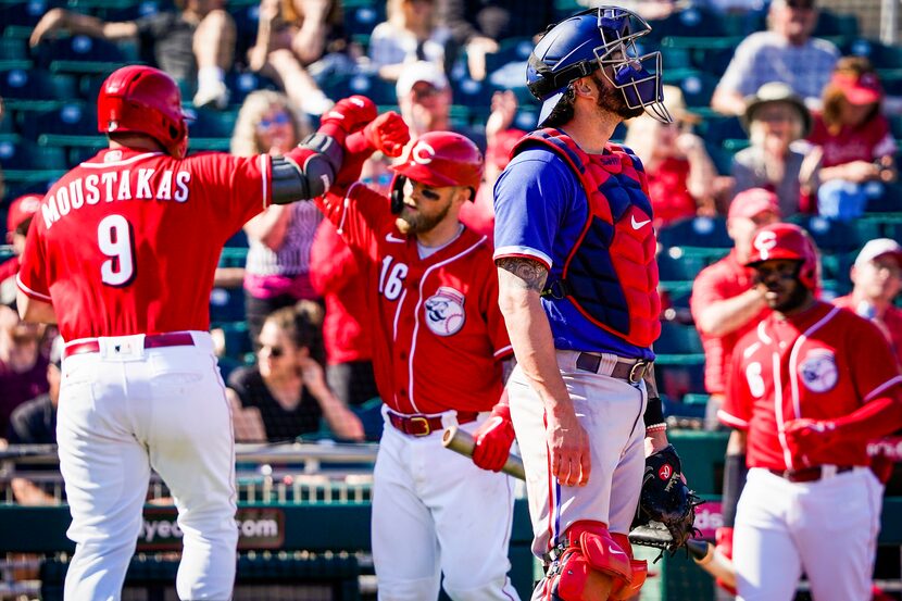 Texas Rangers catcher Blake Swihart looks away as Cincinnati Reds second baseman Mike...