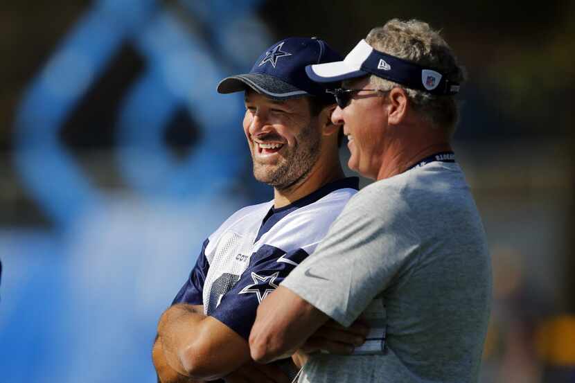 Dallas Cowboys quarterback Tony Romo (left) visits with quarterbacks coach Wade Wilson...