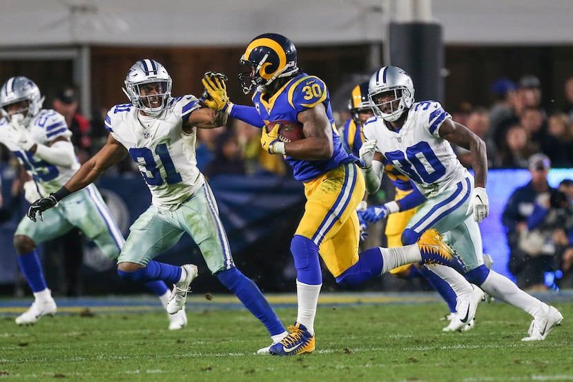 Los Angeles Rams running back Todd Gurley (30) attempts to make a break past Dallas Cowboys...