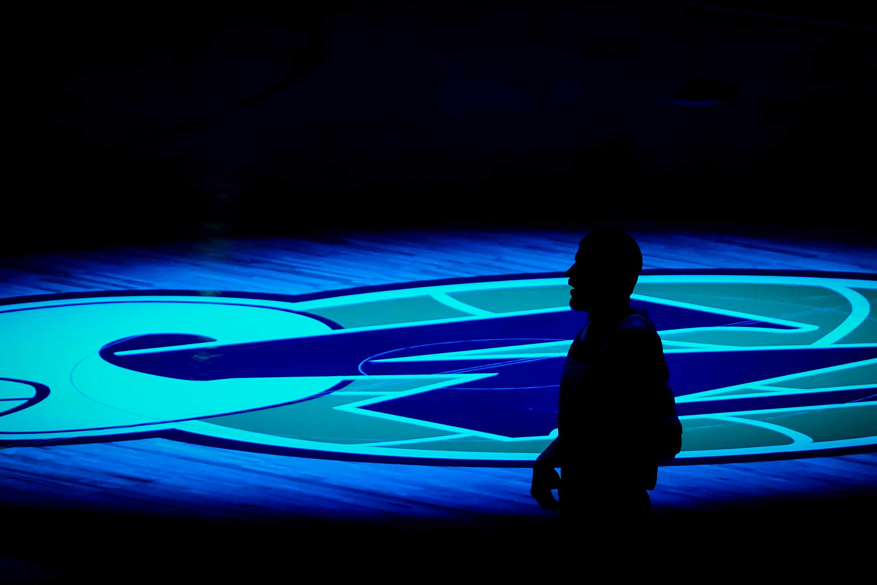 LA Clippers center Ivica Zubac is silhouetted against the Dallas Mavericks logo before an...
