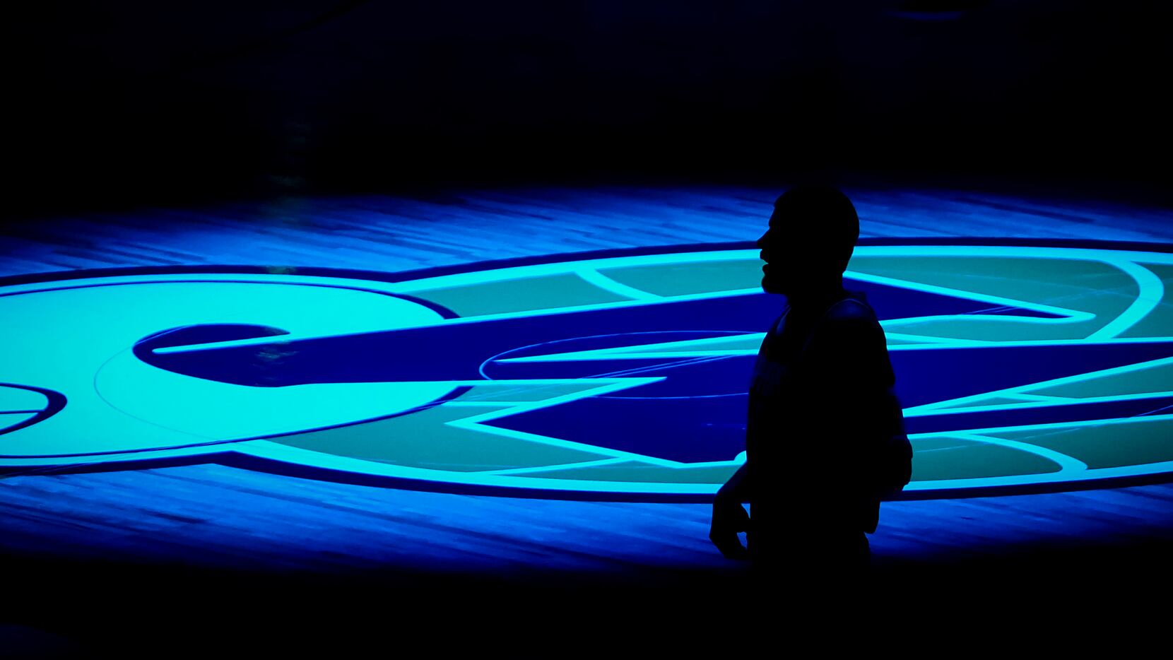 LA Clippers center Ivica Zubac is silhouetted against the Dallas Mavericks logo before an...