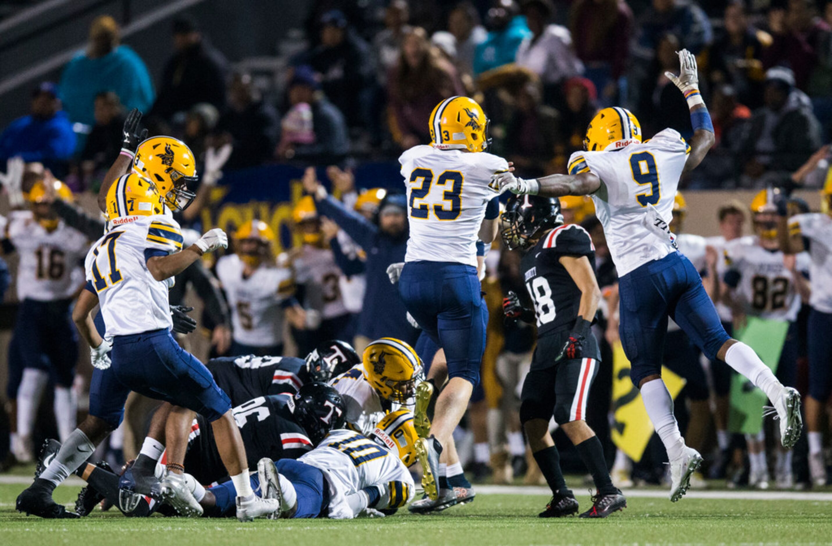 Arlington Lamar players celebrate after defensive back Harold West (10) recovers a fumble...