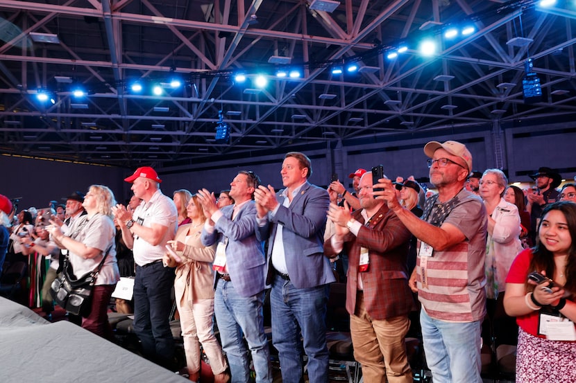 People cheer as Republican presidential candidate former President Donald Trump speaks...