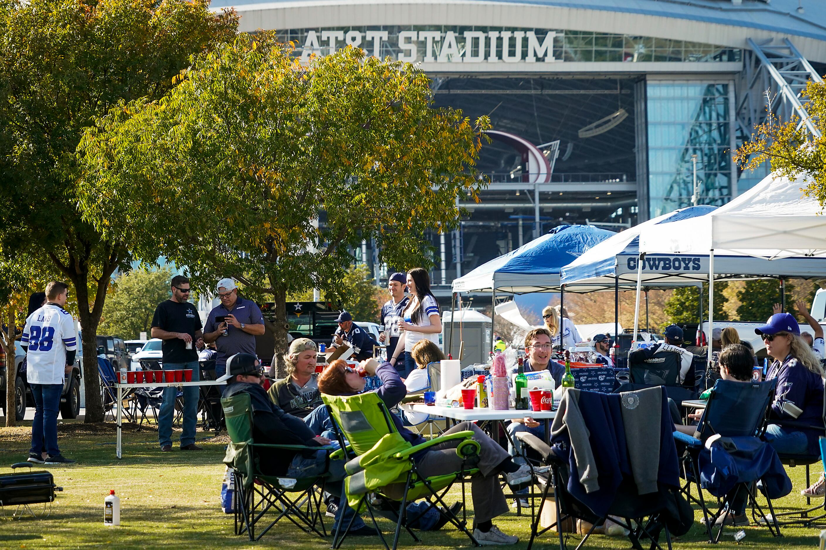 Fans tailgate before an NFL football game between the Dallas Cowboys and the Washington...