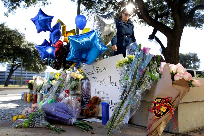 A makeshift memorial honors San Antonio police Officer Benjamin Marconi, 50, a 20-year...