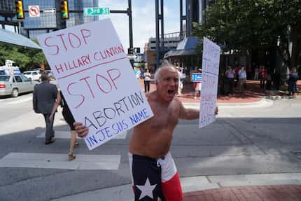 Donald Trump supporter Rives Grogan preaches outside a Republican fundraiser Tuesday in...