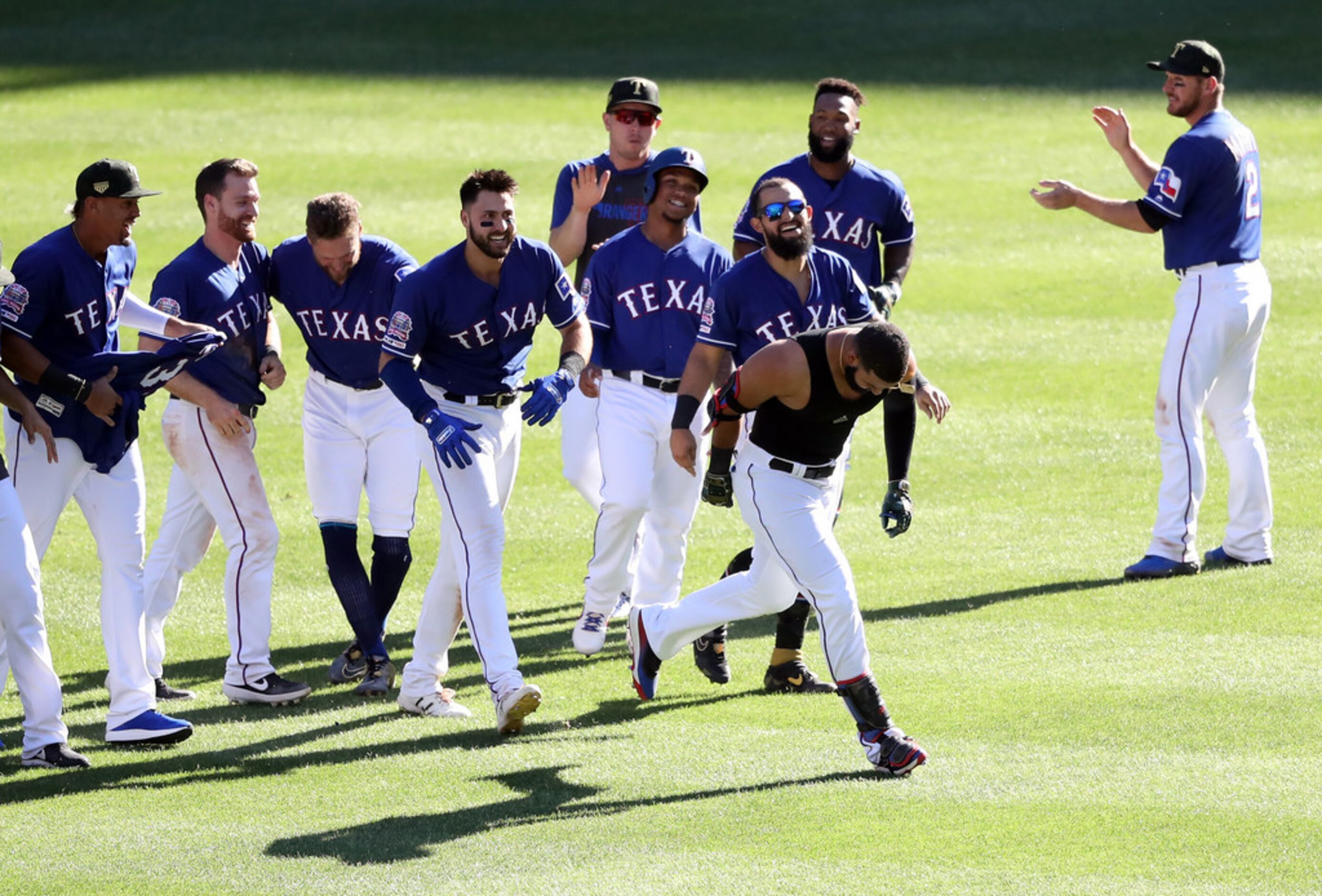 ARLINGTON, TEXAS - MAY 19:  The Texas Rangers celebrate the game winning run scored on a...