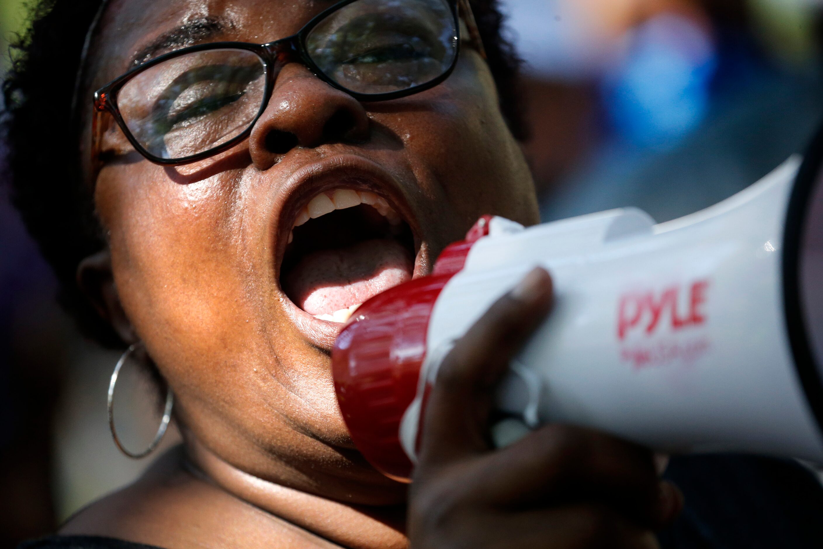 Panda Ross leads the Community of Faith Gathering in song and word as they protested outside...