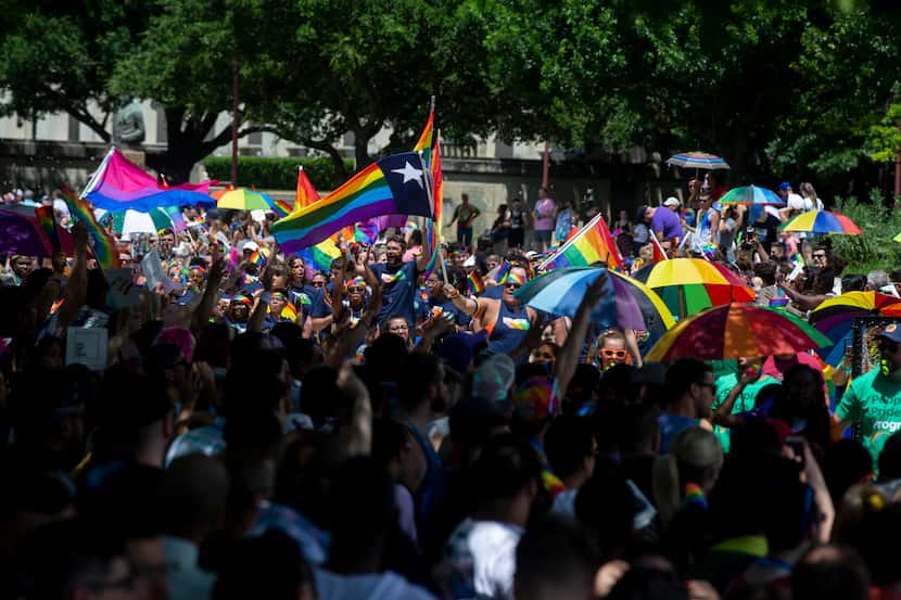 In this June 2, 2019 file photo, parade-goers wave their flags during the annual Dallas...