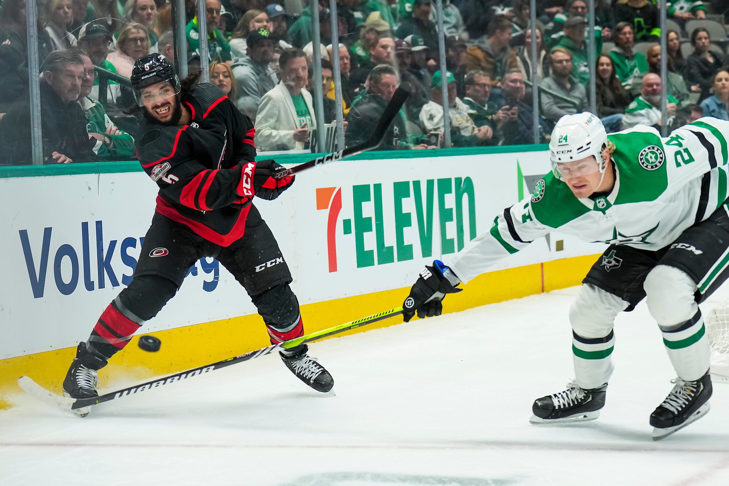 Carolina Hurricanes defenseman Jalen Chatfield (5) clears the puck from behind his own net...