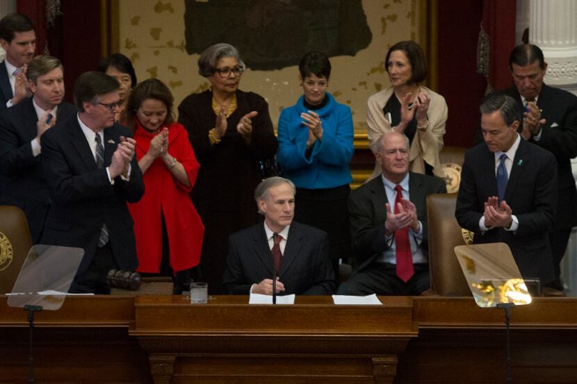 Texas Gov. Greg Abbott (center) delivers his State of the State address to a joint session...