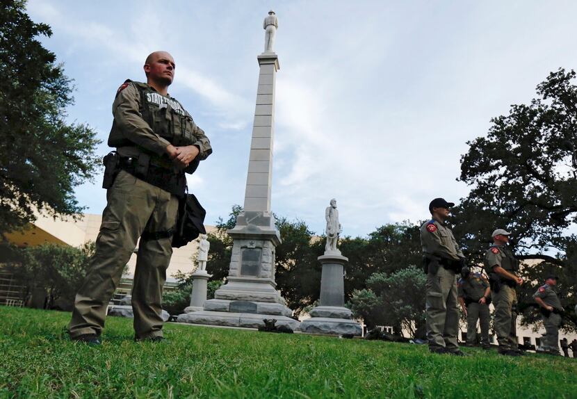 Texas state troopers guard the Confederate War Memorial before the March Against White...