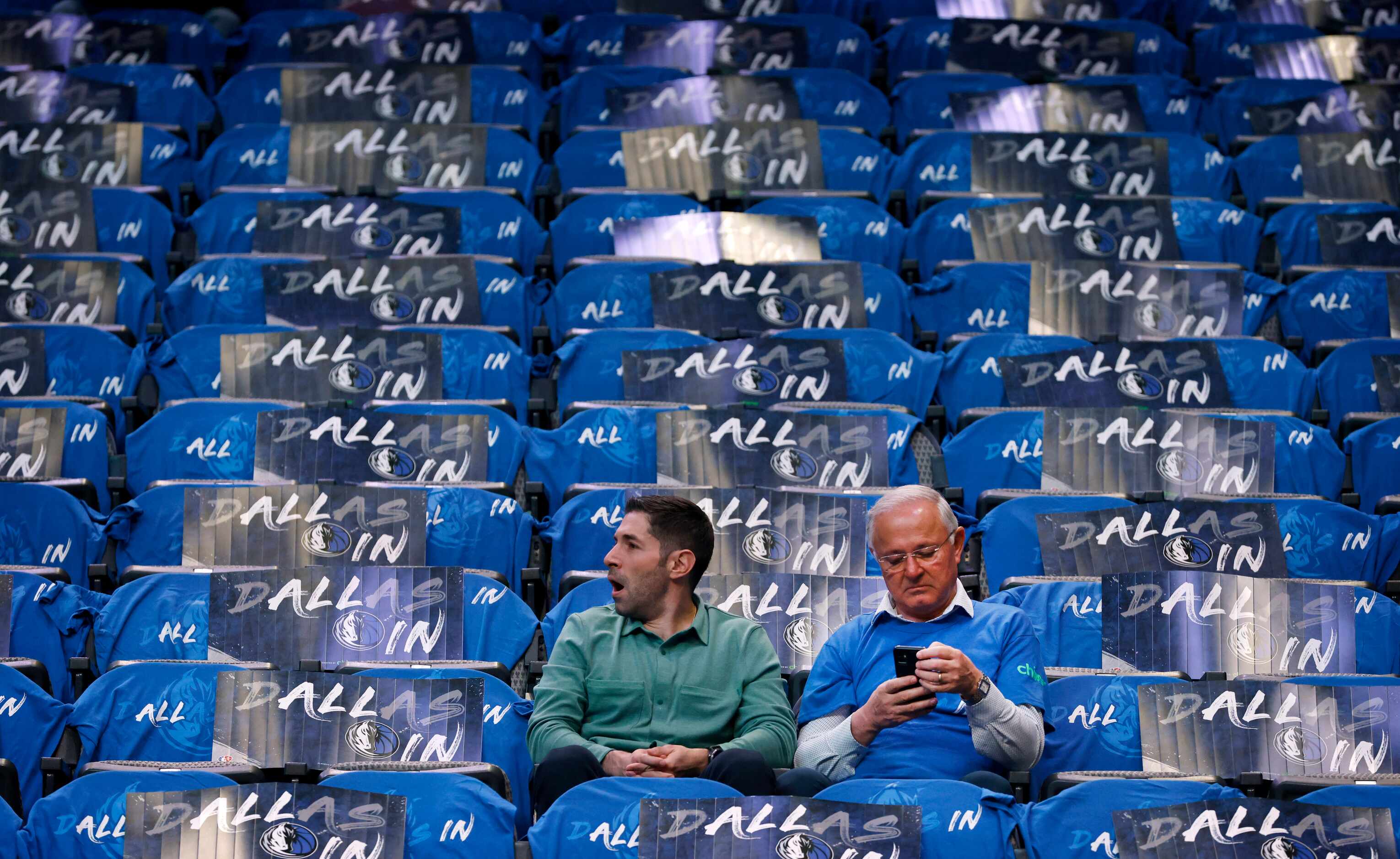 A Dallas Mavericks fan yawns as he takes his seat before an early noon NBA first-round...