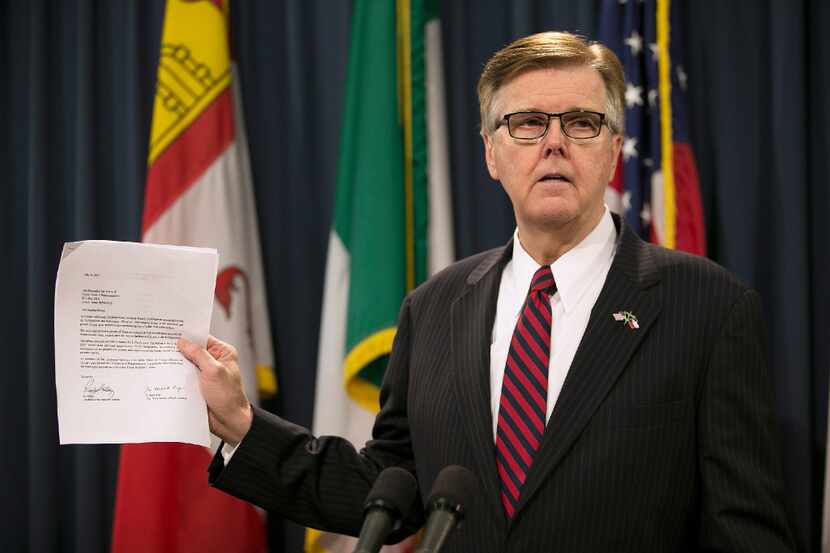 Lt. Governor Dan Patrick holds up a letter supporting property tax relief during a news...