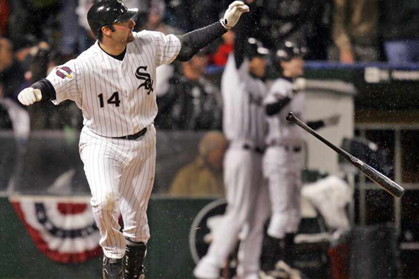  October 23, 2005-- Chicago's Paul Konerko flips his bat away after hammering a...