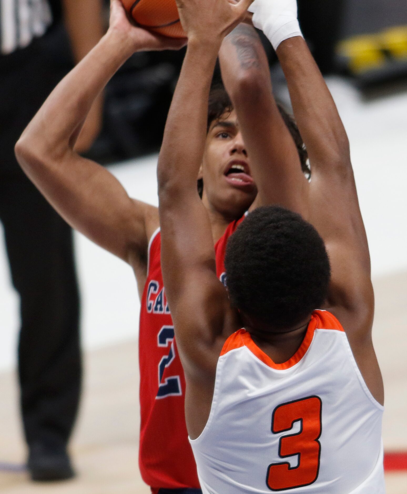 Plano John Paul ll senior Jaylon Tyson (20) shoots over the tight defense of Lancaster's...