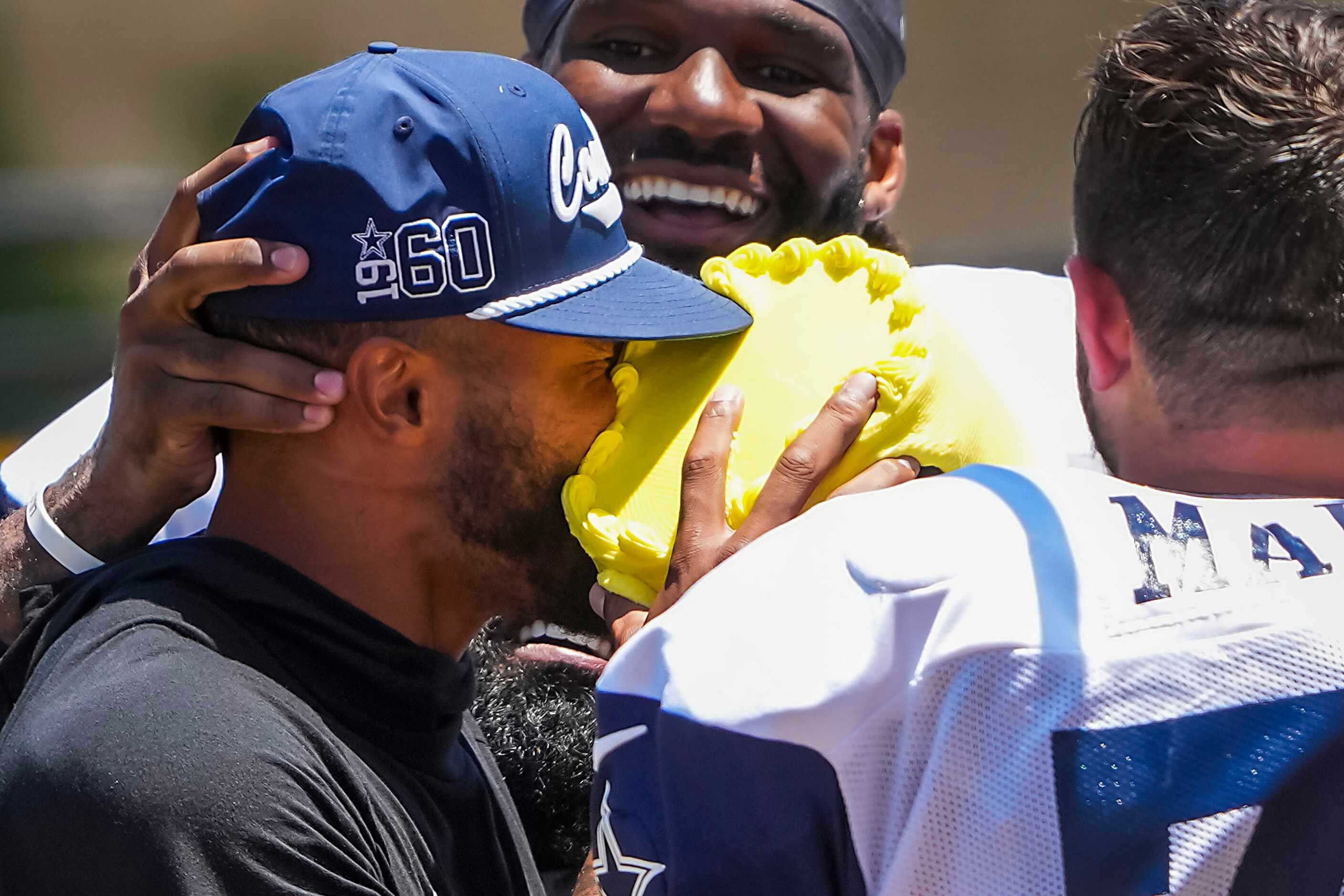 Dallas Cowboys quarterback Dak Prescott gets a cake to the face from his teammates,...