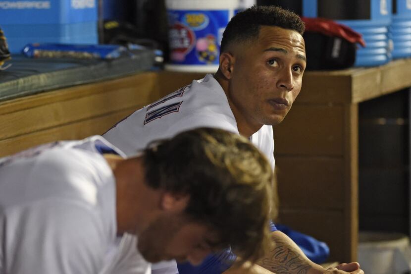 Texas Rangers center fielder Leonys Martin (2) sits in the dugout after he was pulled from...