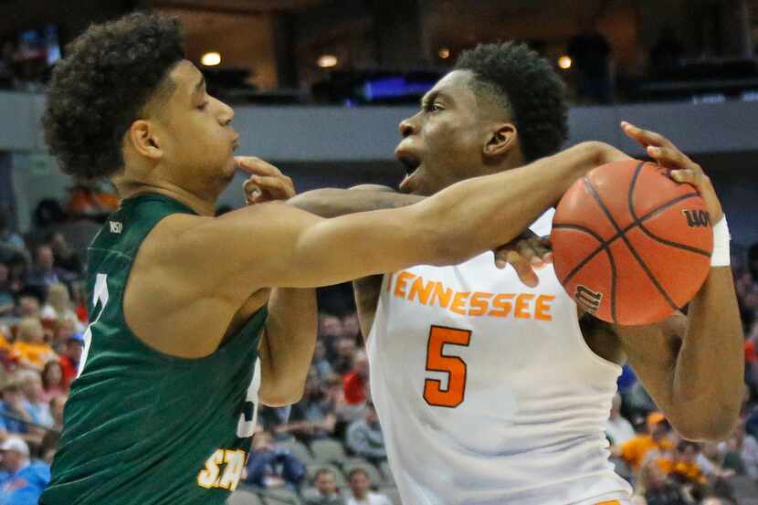 Wright State Raiders guard Mark Hughes (3) applies some tight defense to Tennessee...