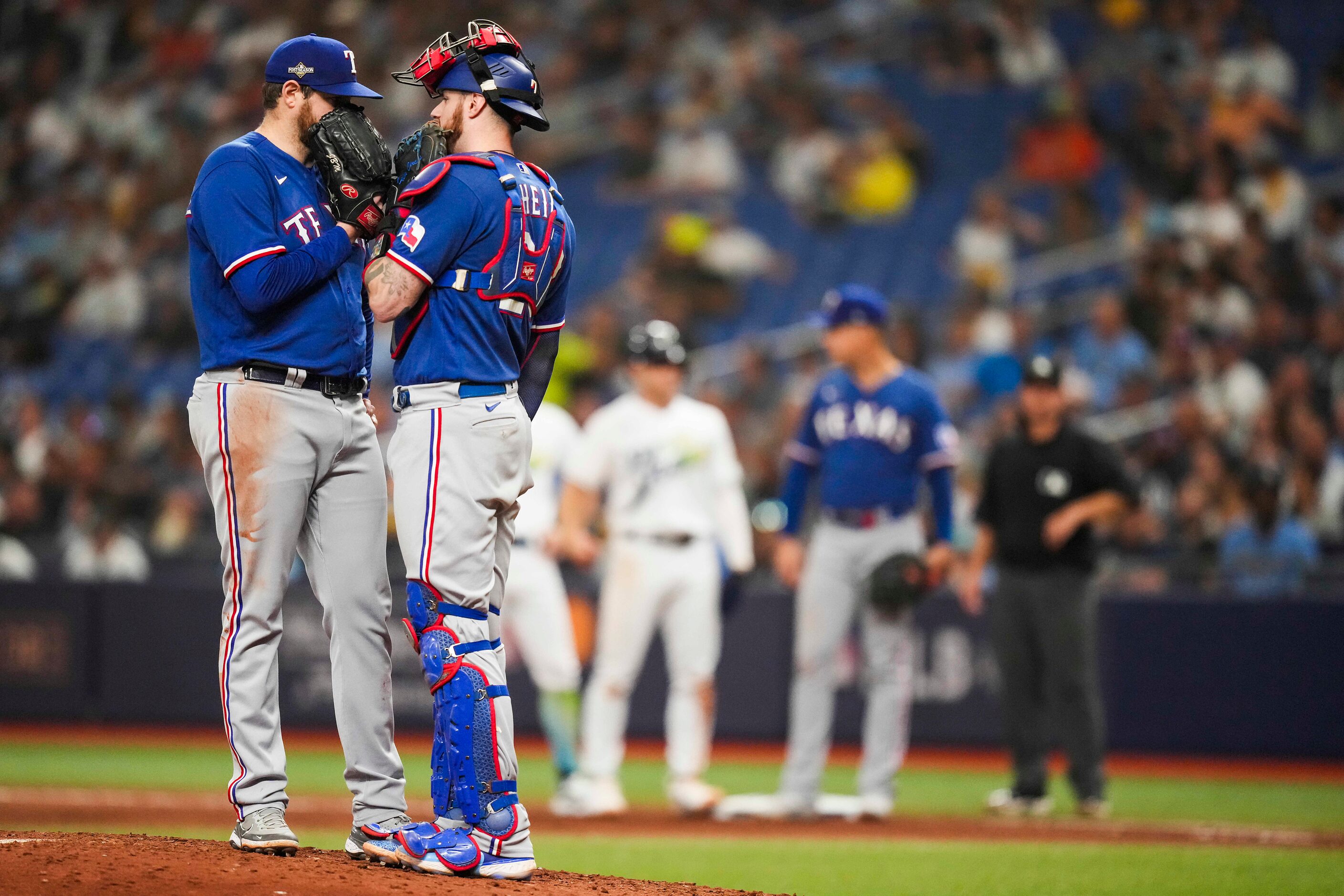 Texas Rangers starting pitcher Jordan Montgomery gets a visit from catcher Jonah Heim during...