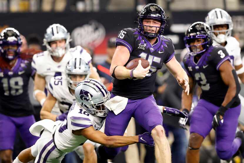 TCU Horned Frogs quarterback Max Duggan (15) caries the ball as he’s tackled by Kansas State...