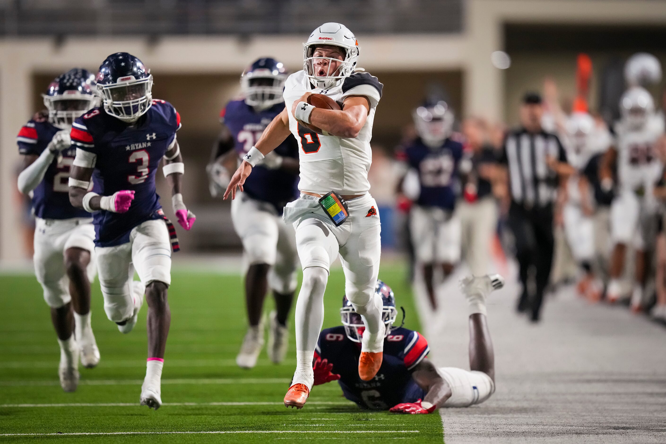 Aledo quarterback Hauss Hejny (8) gets past Denton Ryan linebacker Anthony Hill Jr. (6) on...