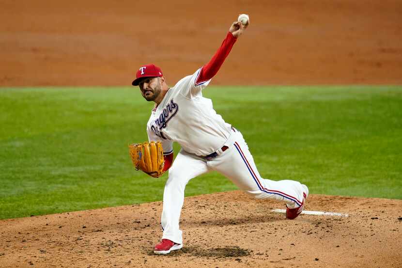 Texas Rangers' Martin Perez throws to the Minnesota Twins in the third inning of a baseball...