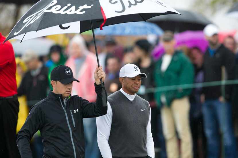 Jan 30, 2015; Scottsdale, AZ, USA; PGA golfer Jordan Spieth holds an umbrella as he walks...
