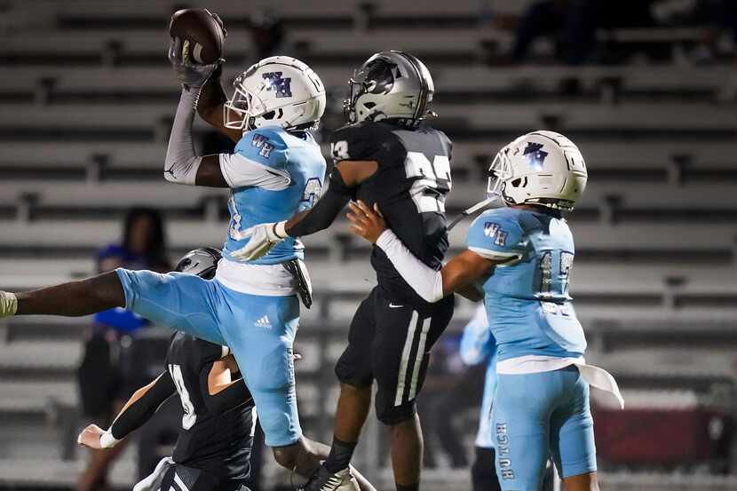 Wilmer-Hutchins wide receiver Jayvon Roe catches a pass as Panther Creek   defensive back...