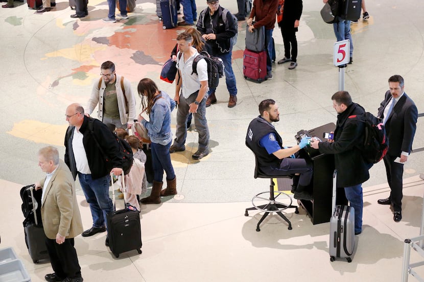 Airline passengers have their documents checked by TSA agents at Dallas Love Field Tuesday,...