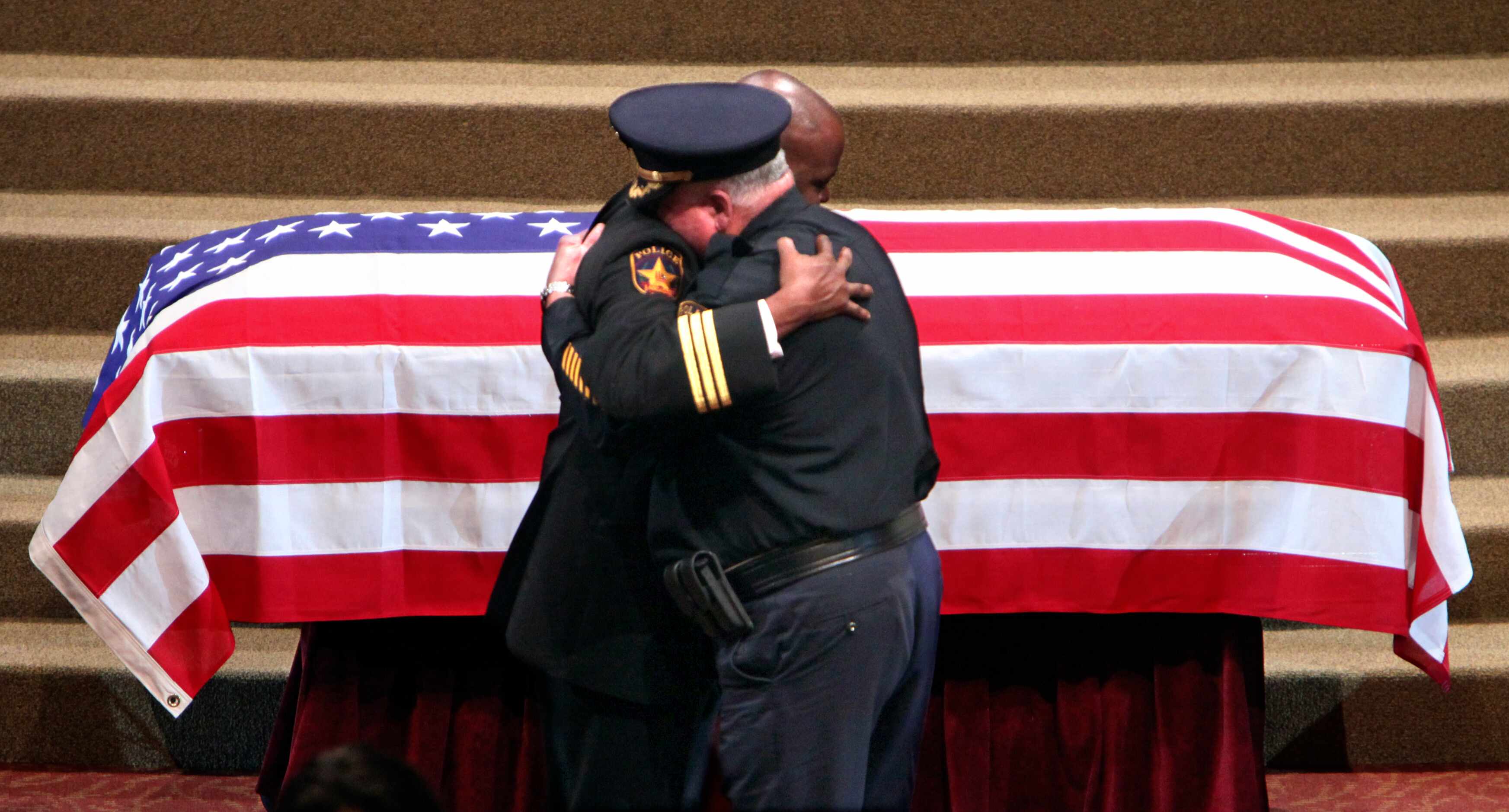 Lancaster Police Chief Keith Humphrey (left) and assistant chief Larry Flatt embraced at the...