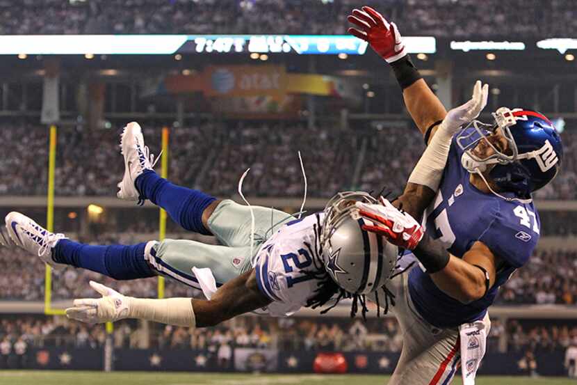  December, 11, 2011--Dallas cornerback Michael Jenkins (21) goes horizontal to defend a pass...