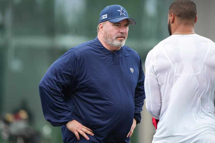 Dallas Cowboys head coach Mike McCarthy talks with quarterback Dak Prescott during a...