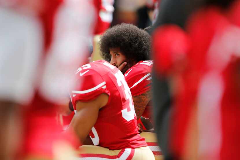 San Francisco 49ers quarterback Colin Kaepernick (7) kneels as the National Anthem is sung...