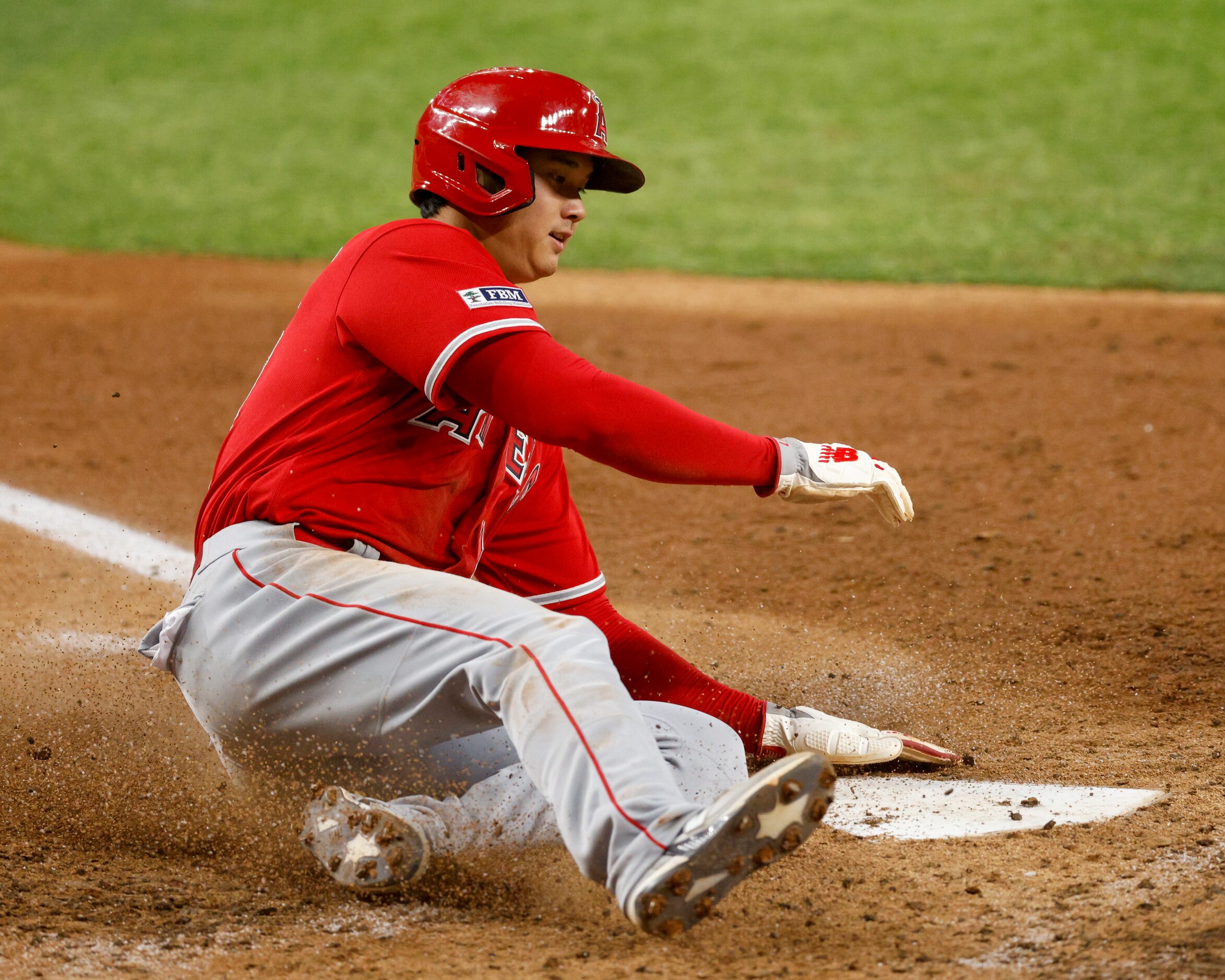 Los Angeles Angels designated hitter Shohei Ohtani (17) slides home to score a run after a...