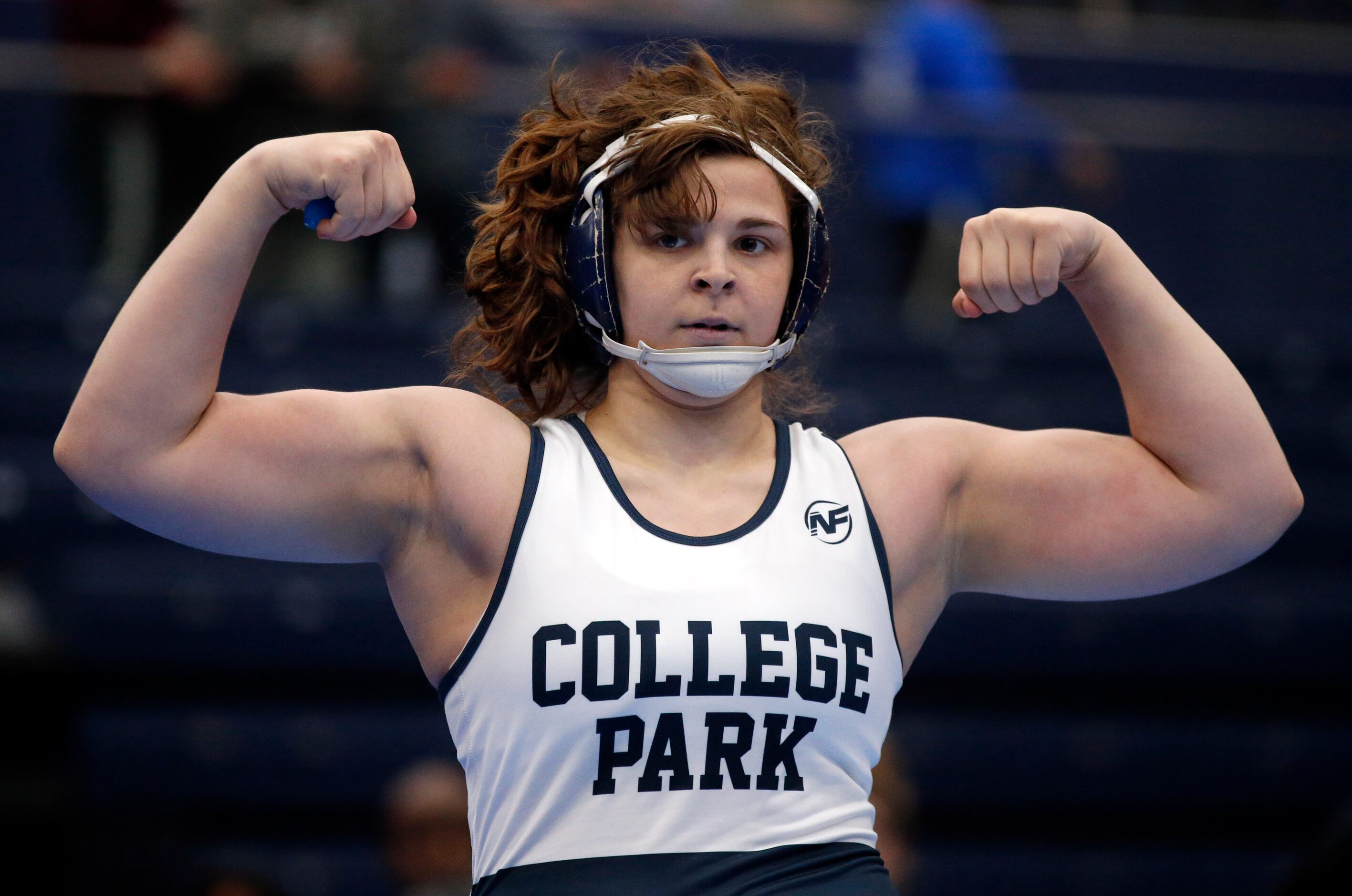 College Park High girls wrestler Brittyn Corbishley flexes her muscles after defeating...
