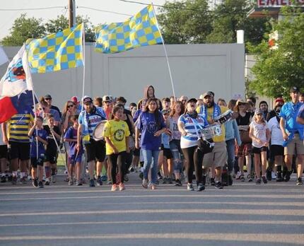 Fort Worth Vaqueros fans march to a match.