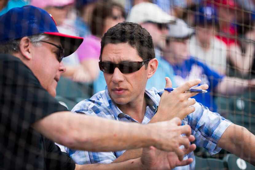 Texas Rangers General Manager Jon Daniels  (facing) talks with Neil Leibman, Rangers ...