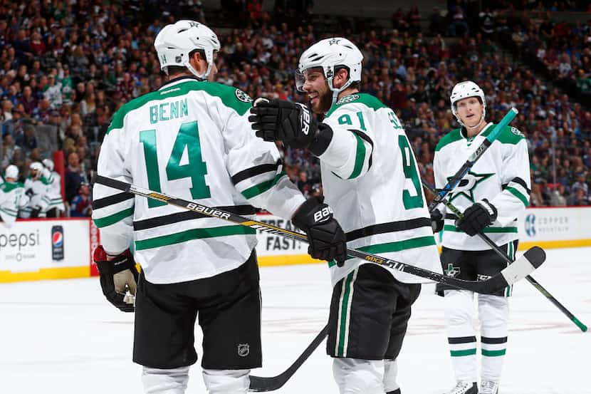 Dallas Stars left wing Jamie Benn (14) is congratulated by teammate Tyler Seguin (91) after...