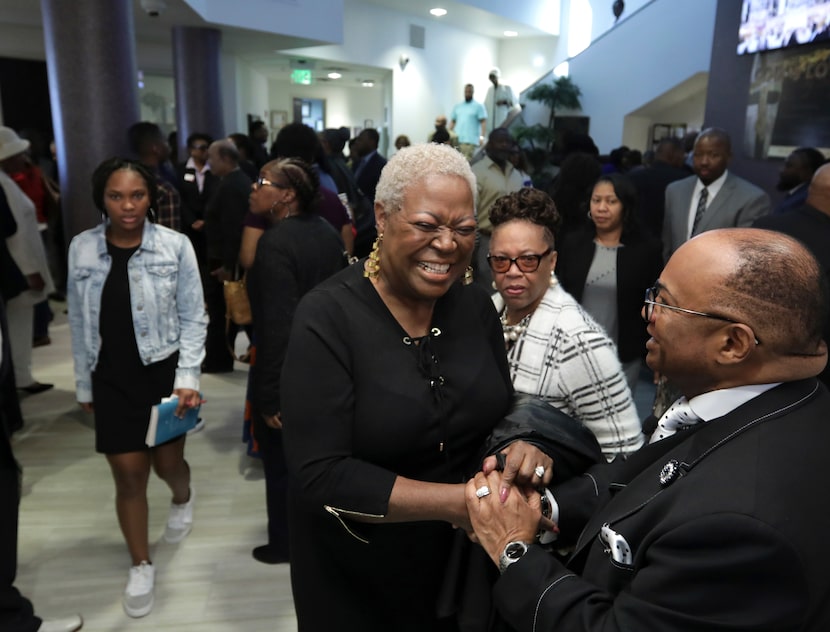 Pastor Isiah Joshua Jr. (right) meets with members of the congregation at Shiloh Missionary...