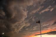 Storm clouds gathered over a Texas flag in Dallas in November 2022. (File Photo)