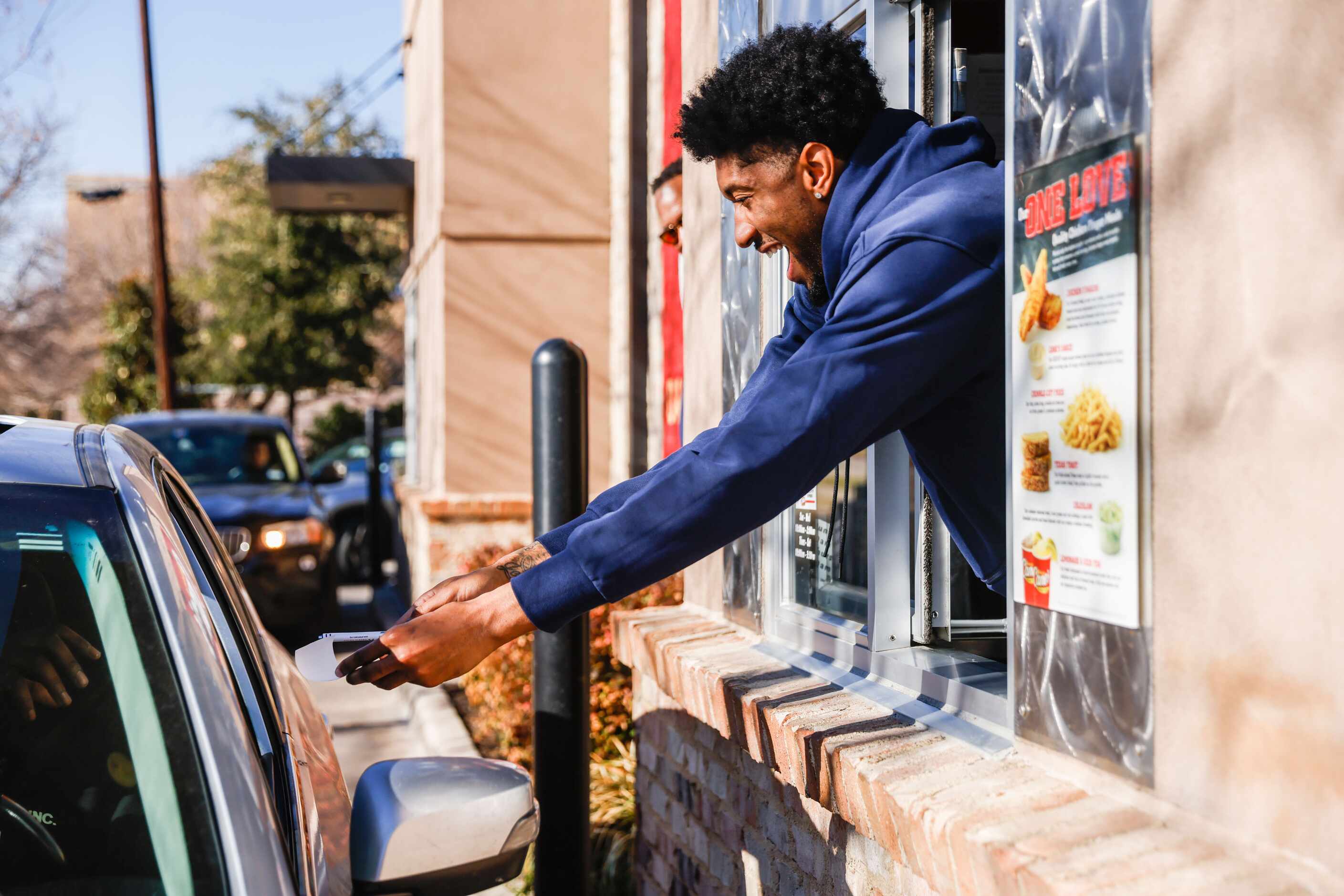 Mavericks player Christian Wood gives an autograph to a costumer at the Raising Cane’s in...